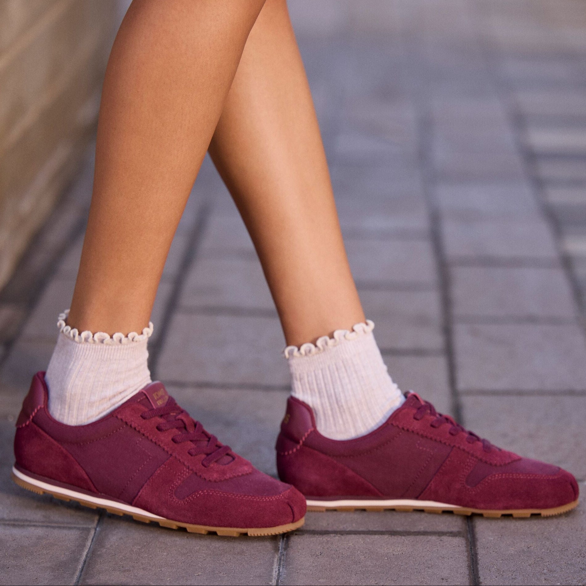 On model image of the Womens TRVL Lite Palisade Sneaker Water Repellent Burgundy Vintage Twill