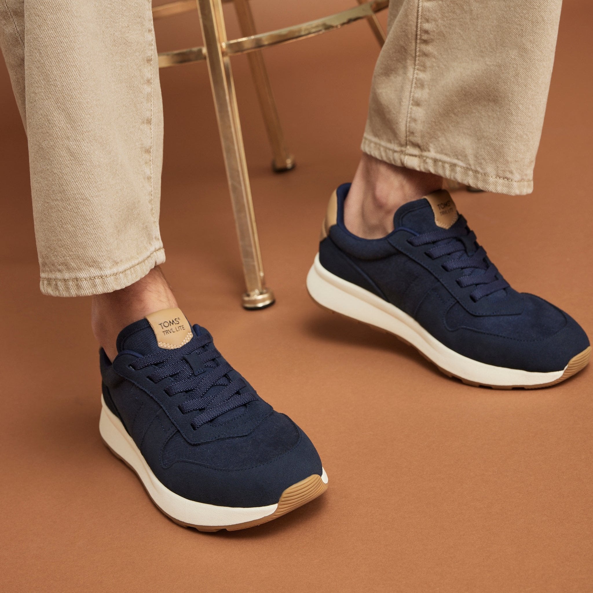mens retro runner sneaker on model up close detail shot in navy textile and suede
