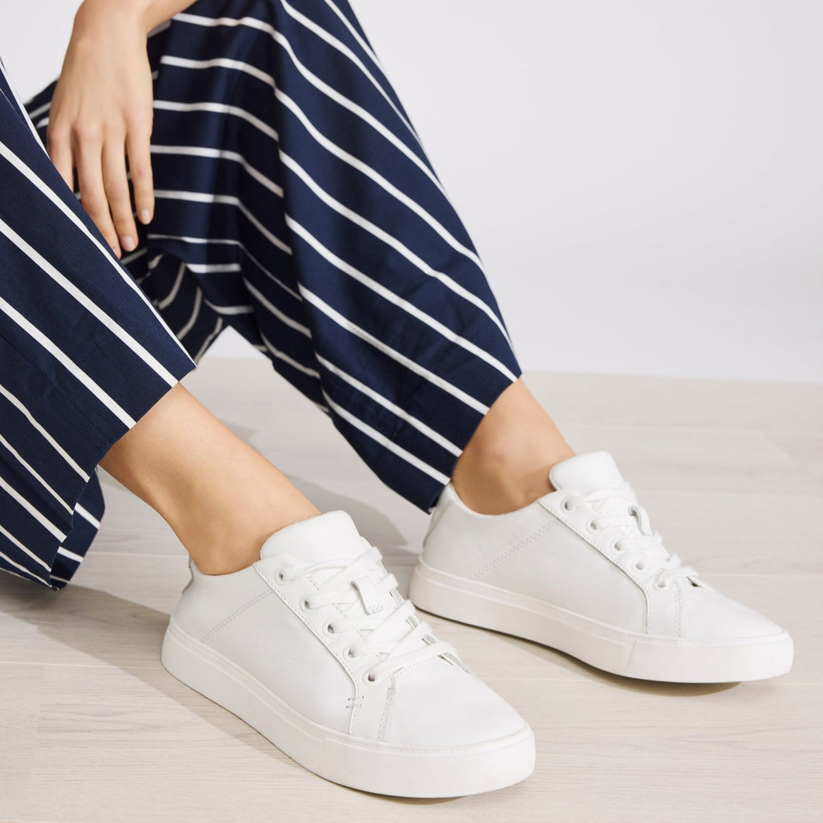 On figure image of the white leather Kameron lace up sneaker