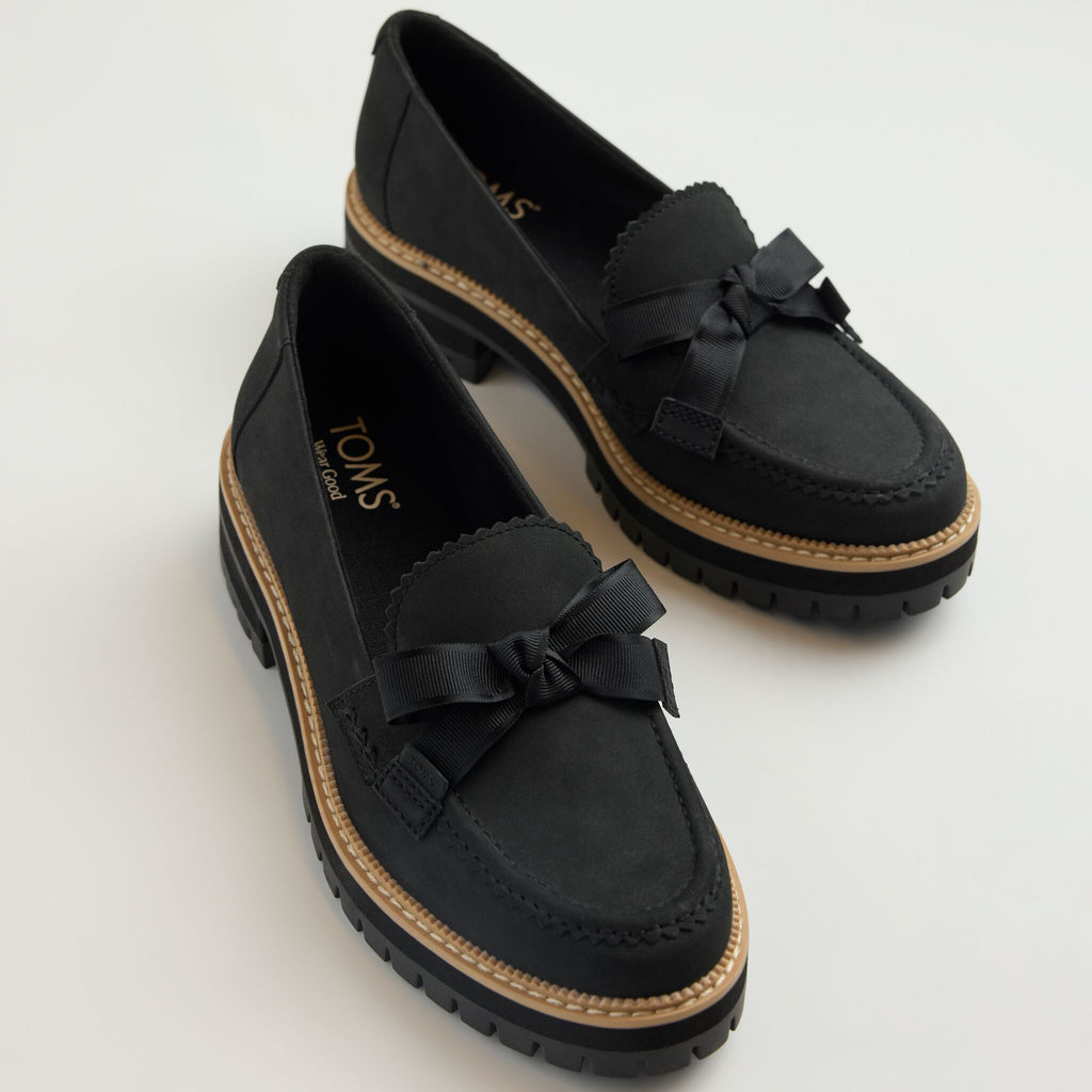 Laydown detail image of the black Cara loafer with bow detail