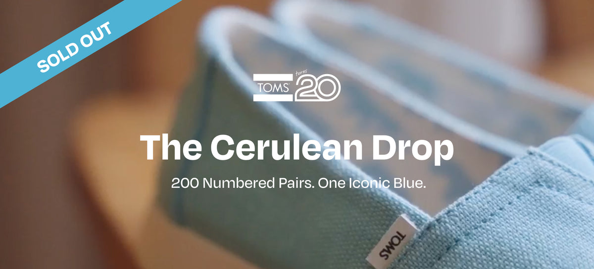 SOLD OUT. TOMS turns 20 logo. The Cerulean Drop. 200 Numbered Pairs. One Iconic Blue. Explore the Drop. Alpargatas and beach background.