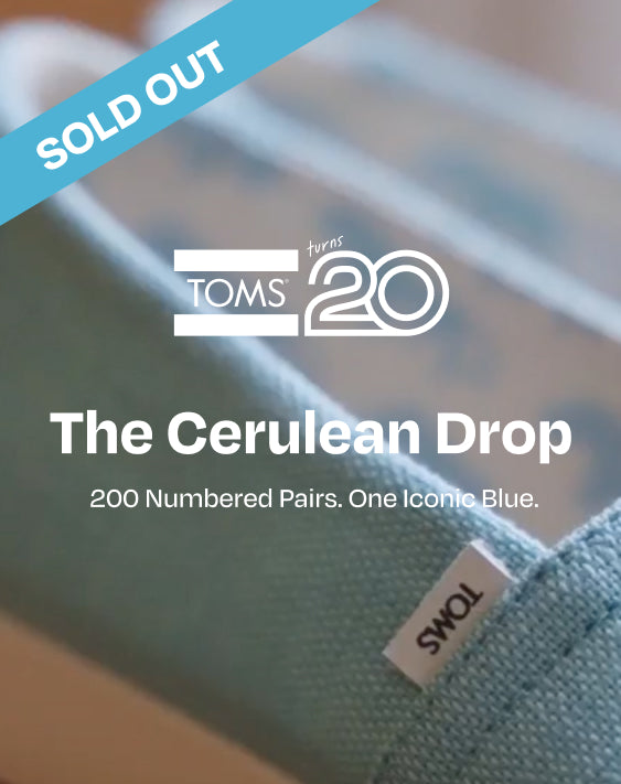 SOLD OUT. TOMS turns 20 logo. The Cerulean Drop. 200 Numbered Pairs. One Iconic Blue. Explore the Drop. Alpargatas and beach background.