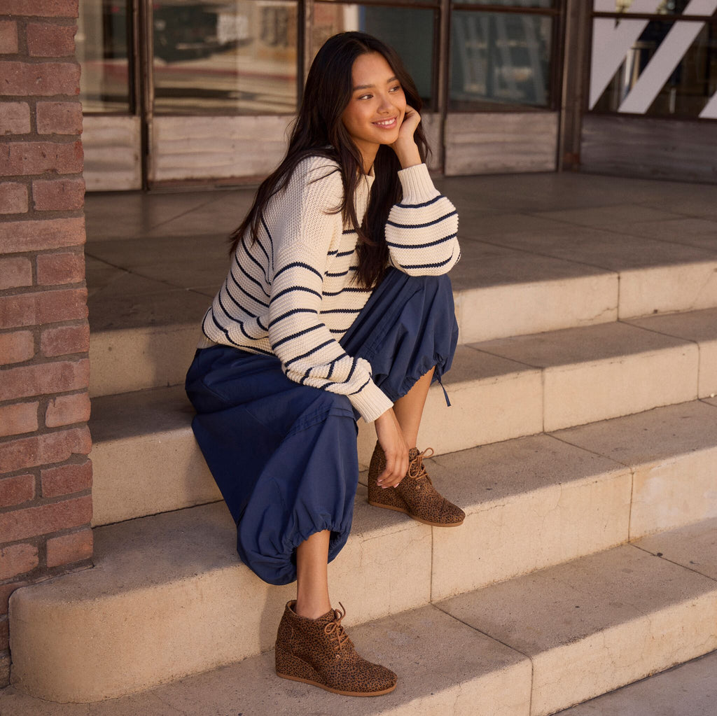 On model image of the leopard print desert wedge boot