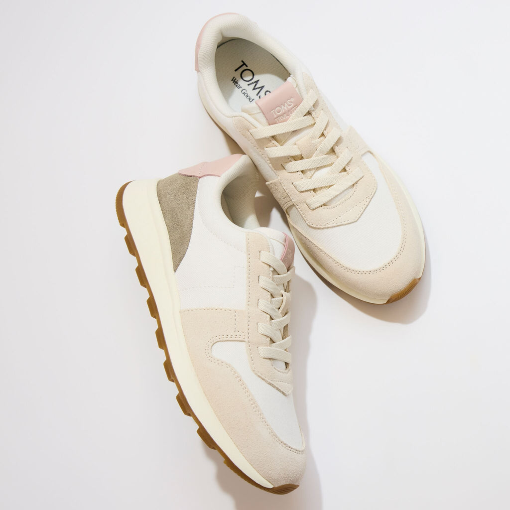Laydown detail image of the ivory TRVL Lite retro sneaker