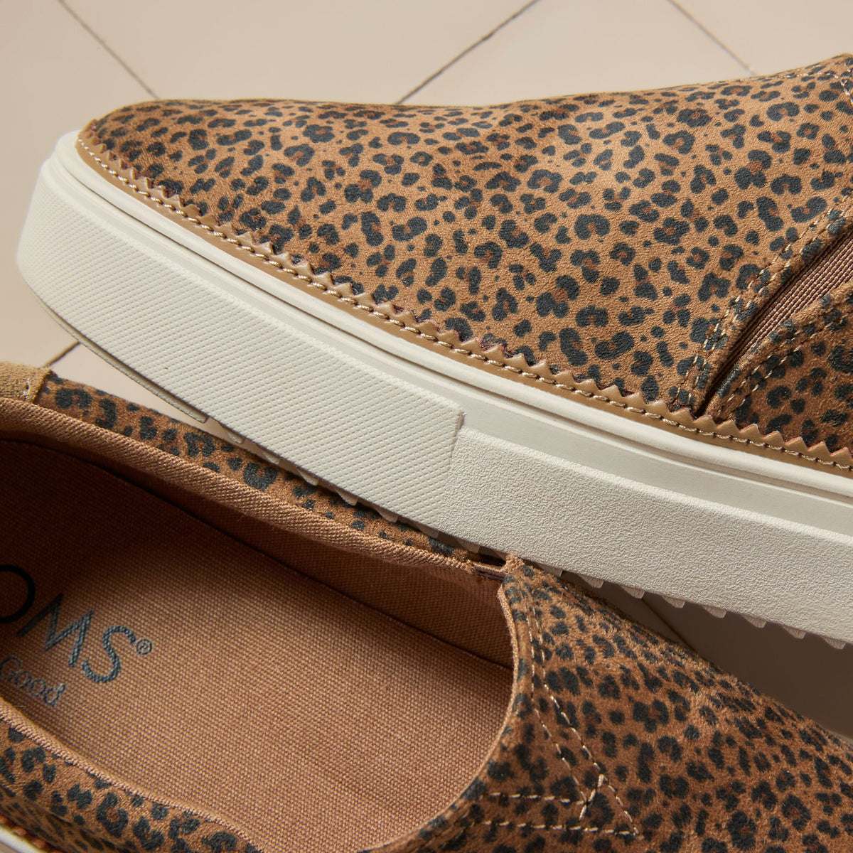 Laydown detail image of the toffee leopard Emily slip on sneaker