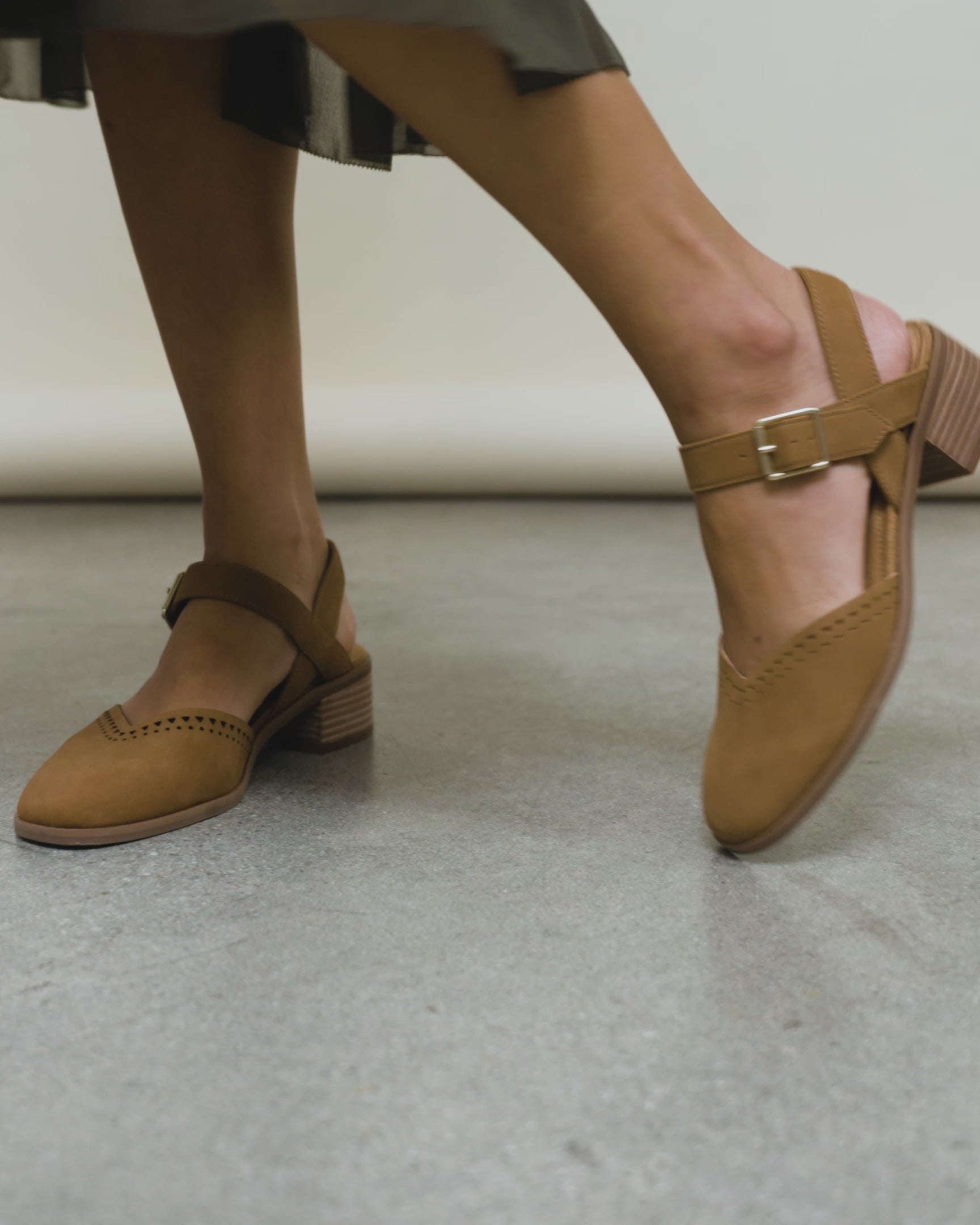 Jaclyn heel on model, walking, styled with green skirt