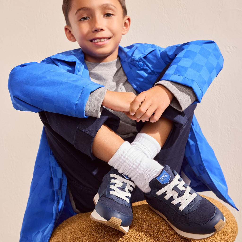 On model image of the navy Youth TRVL Lite retro sneaker